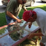 men fixing a window