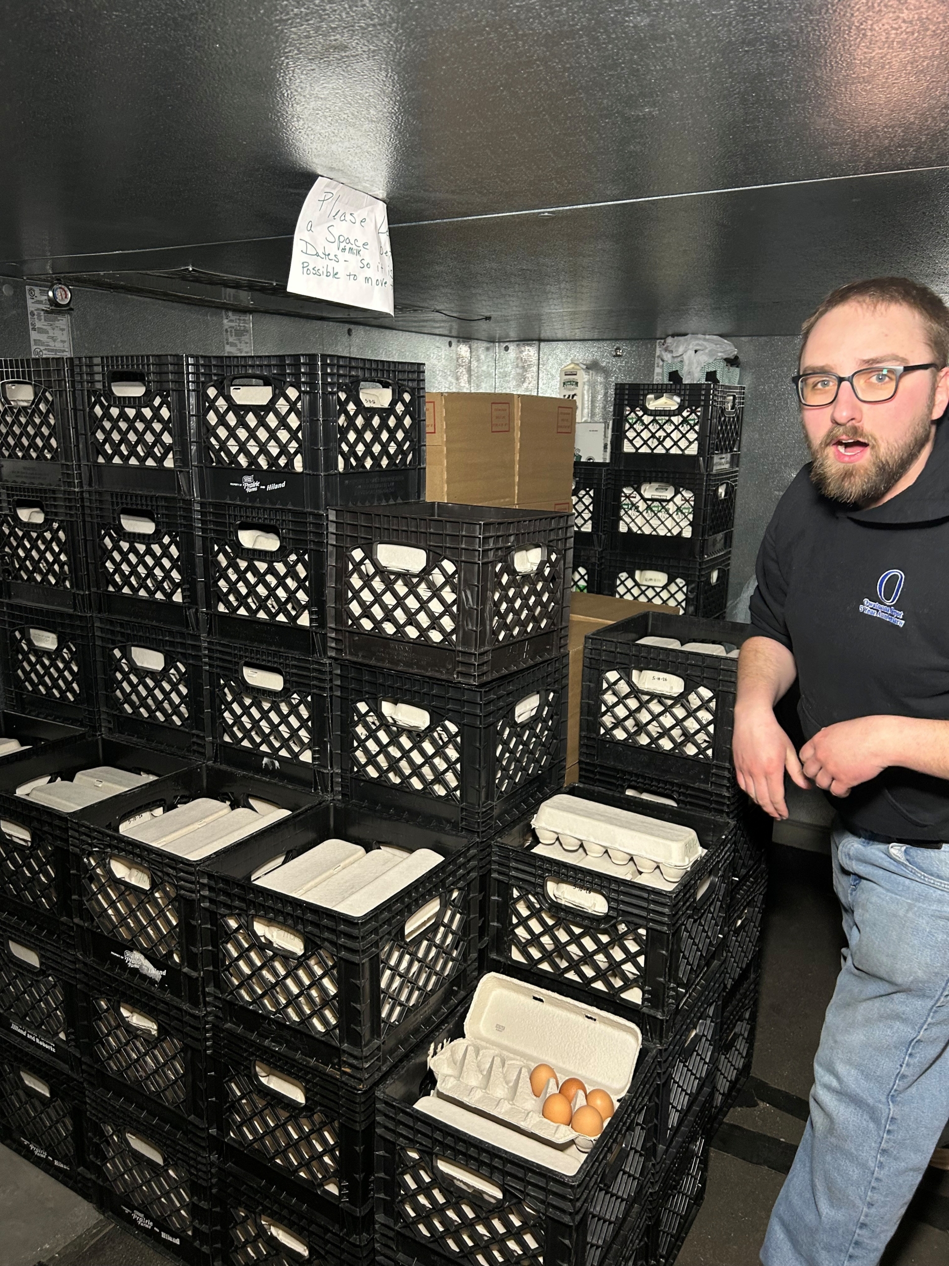 A young man sorting cartons of eggs at Community Pathways
