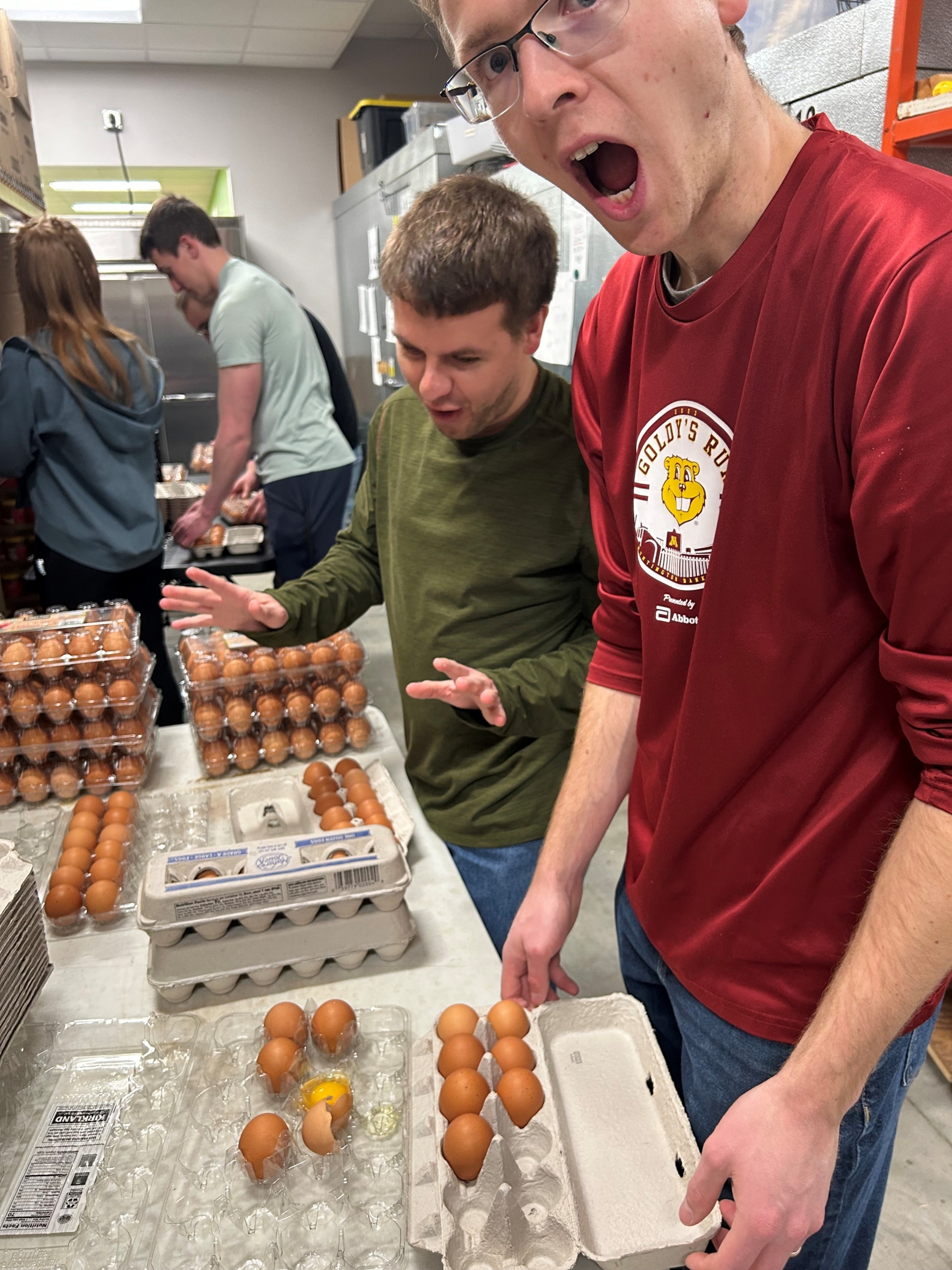 Two young men sorting food at Community Pathways