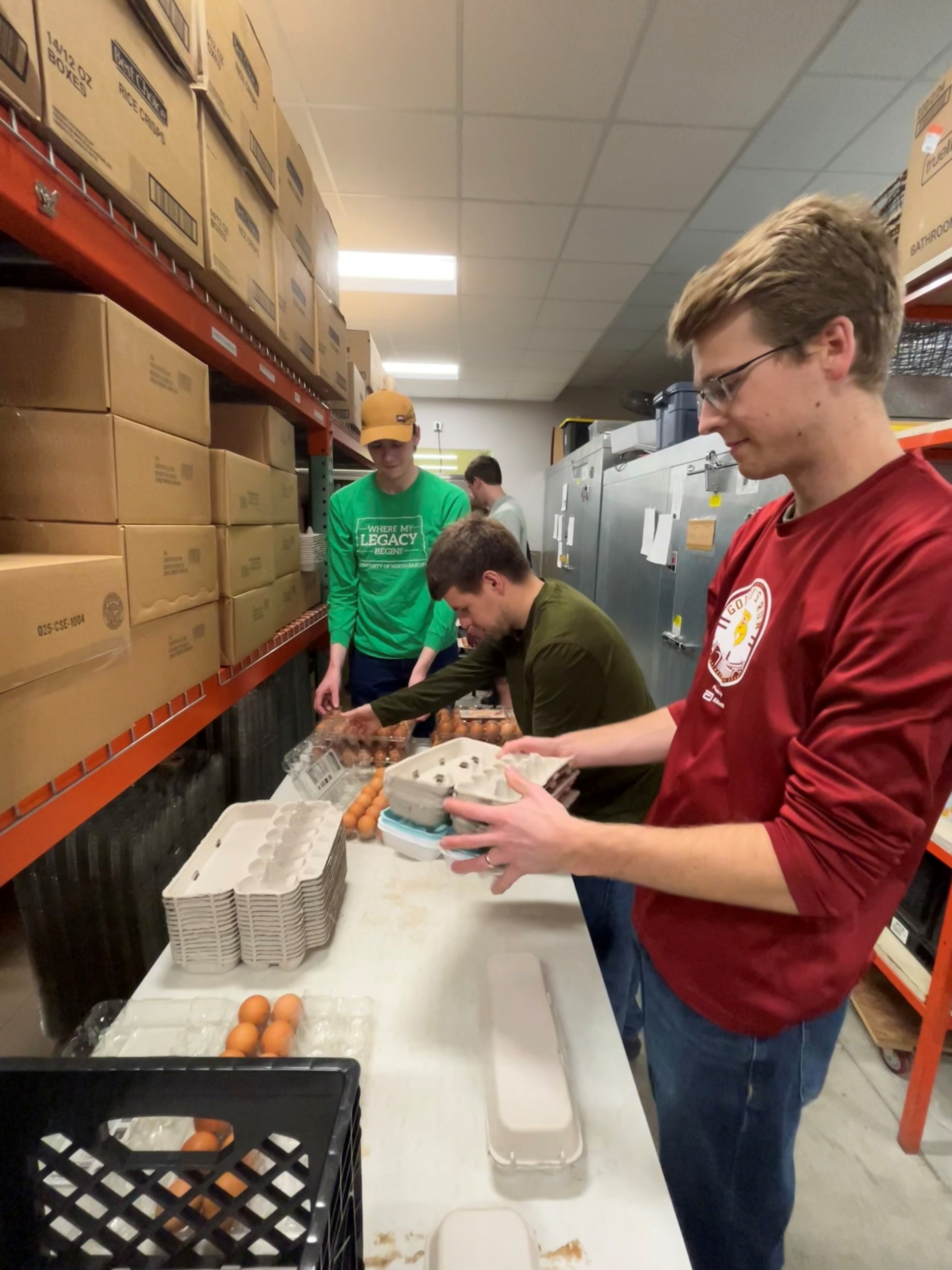 Young men sorting eggs at Community Pathways